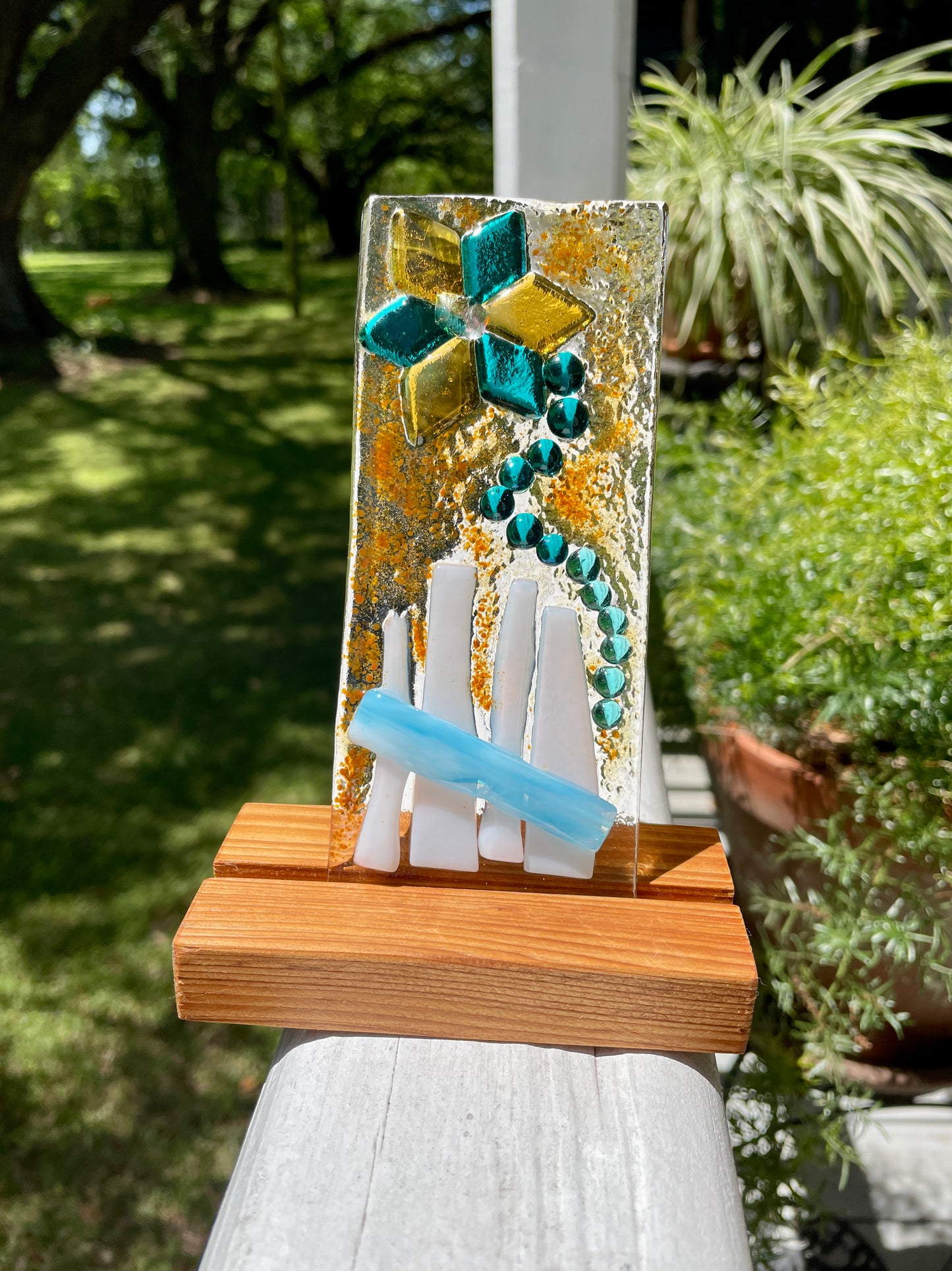 Blue and gold flower on fence